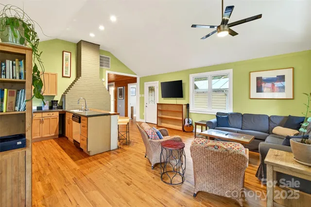 a living room with furniture a flat screen tv and a table