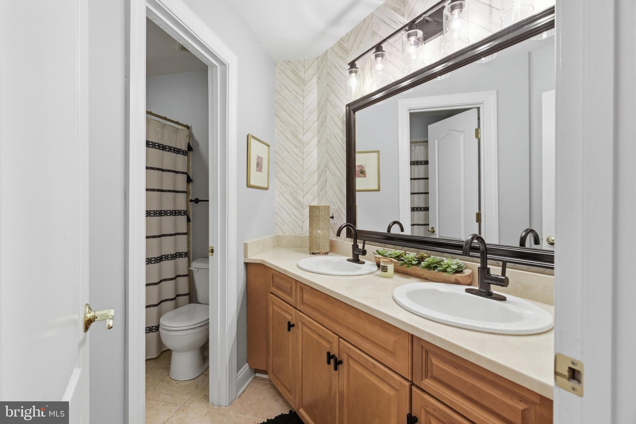 1219 Meadow View Road Pasadena, MD 21122 - Photo 41 of 70 Elegant dual-sink bathroom retreat.