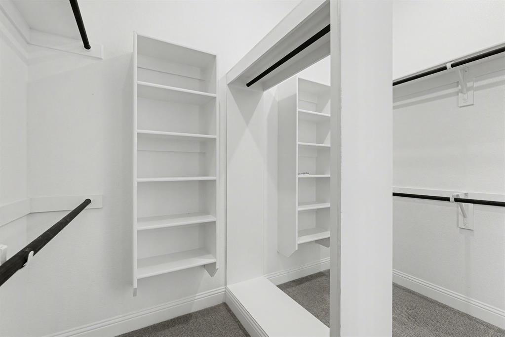 7041 Champion Road Midlothian, TX 76065 - Photo 14 of 30 a view of walk in closet with empty racks