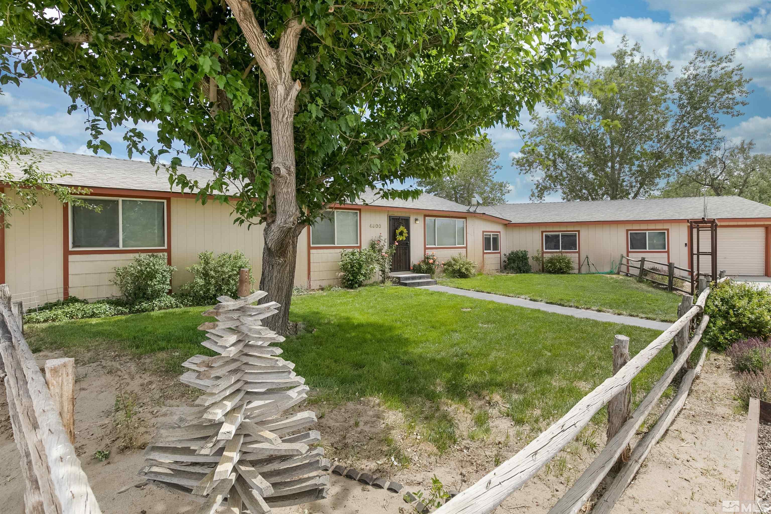 4300 Cox Road Fallon, NV 89406 - Photo 1 of 24 a front view of a house with a yard table and chairs
