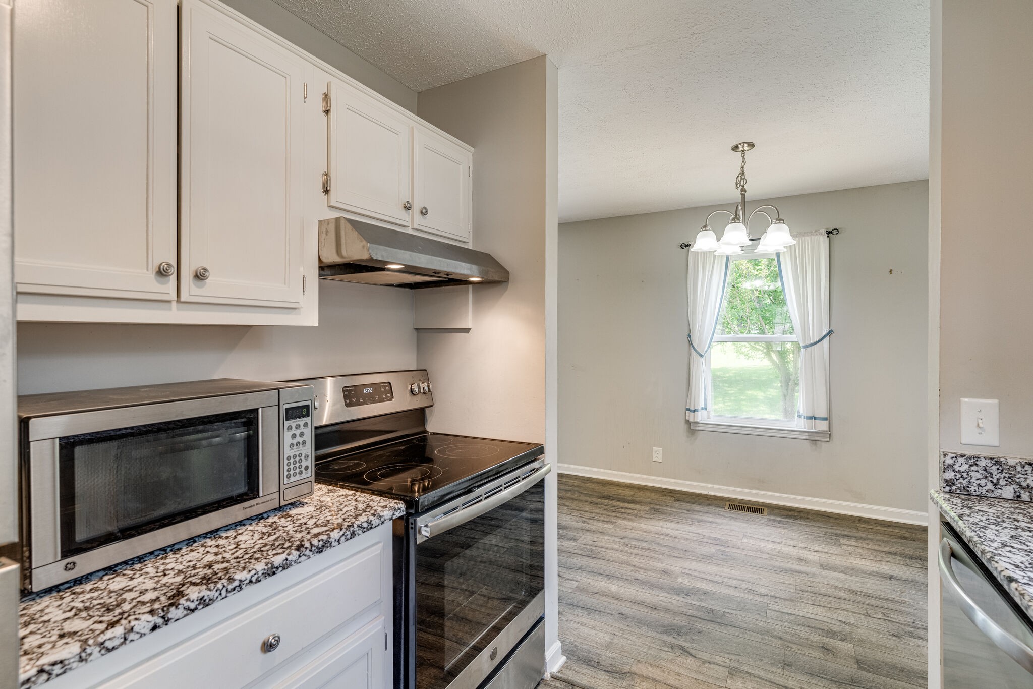 4752 Lahr Road Springfield, TN 37172 - Photo 9 of 27 a kitchen with granite countertop a stove a microwave and cabinets