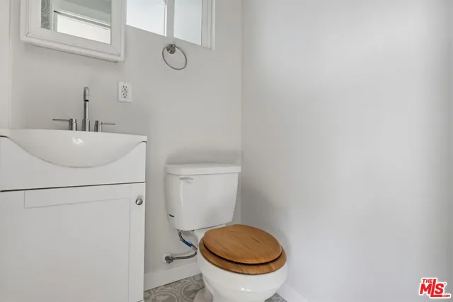 a bathroom with a sink a toilet and a mirror
