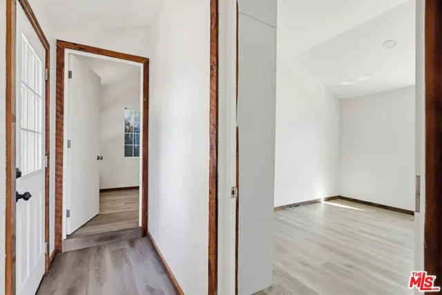 a view of a hallway with wooden floor