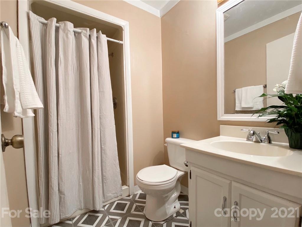 814 Calhoun Trail Rutherfordton, NC 28139 - Photo 13 of 14 a bathroom with a toilet sink and a mirror