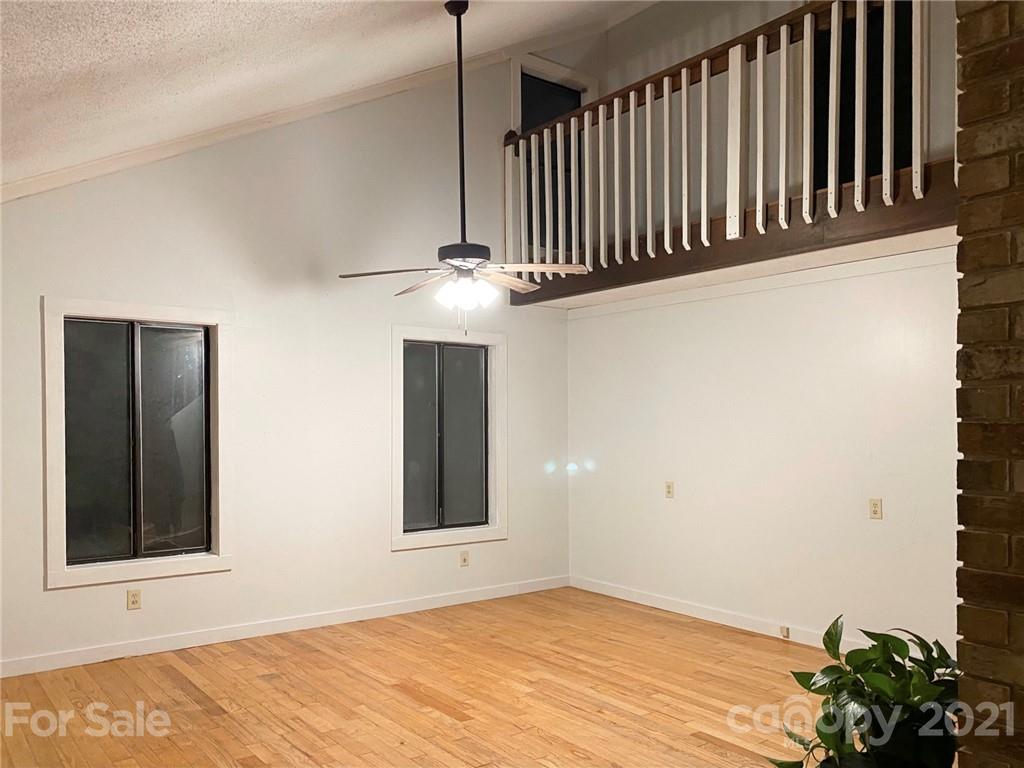 814 Calhoun Trail Rutherfordton, NC 28139 - Photo 5 of 14 a view of an empty room with wooden floor and a window