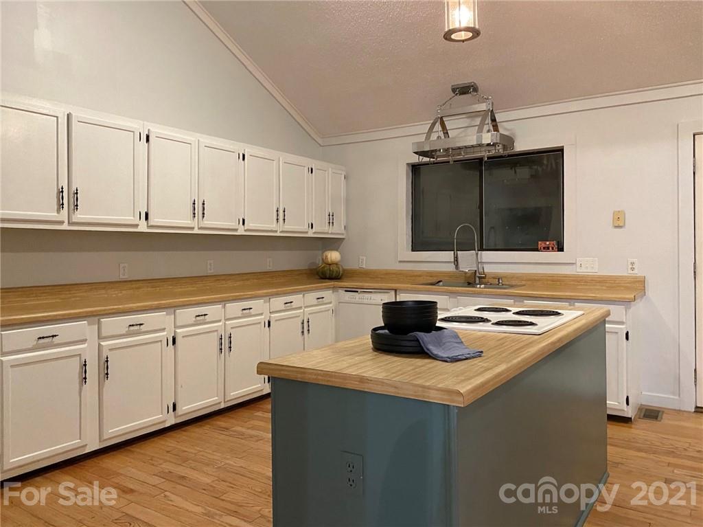 814 Calhoun Trail Rutherfordton, NC 28139 - Photo 8 of 14 a kitchen with stainless steel appliances granite countertop a sink stove and cabinets