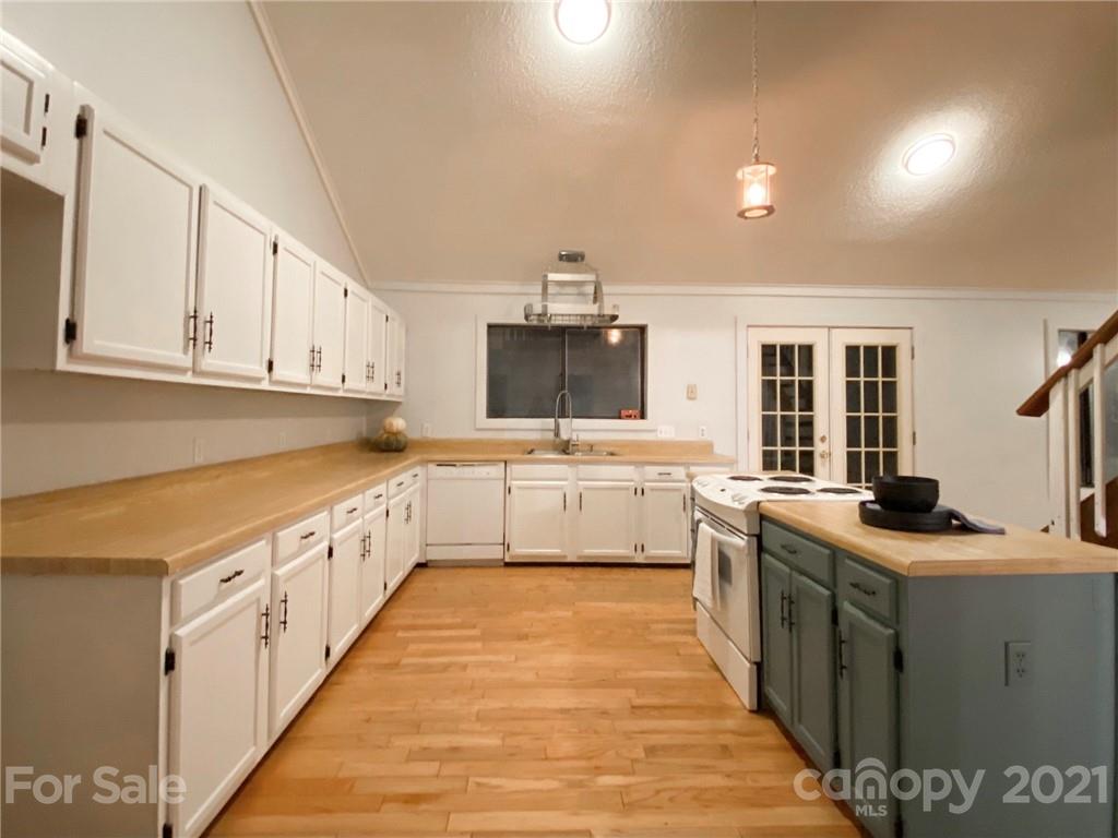 814 Calhoun Trail Rutherfordton, NC 28139 - Photo 10 of 14 a large white kitchen with granite countertop a sink and cabinets