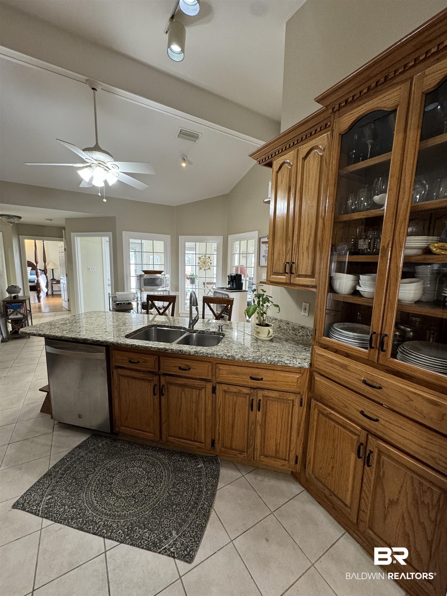 15165 Daugherty Road Foley, AL 36535 - Photo 17 of 70 Kitchen featuring stainless steel dishwasher, ceiling fan, vaulted ceiling, light tile patterned floors, and sink