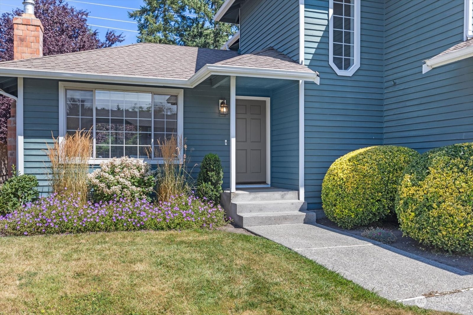 815 213th Street Southeast Bothell, WA 98021 - Photo 2 of 37 a front view of a house with garden