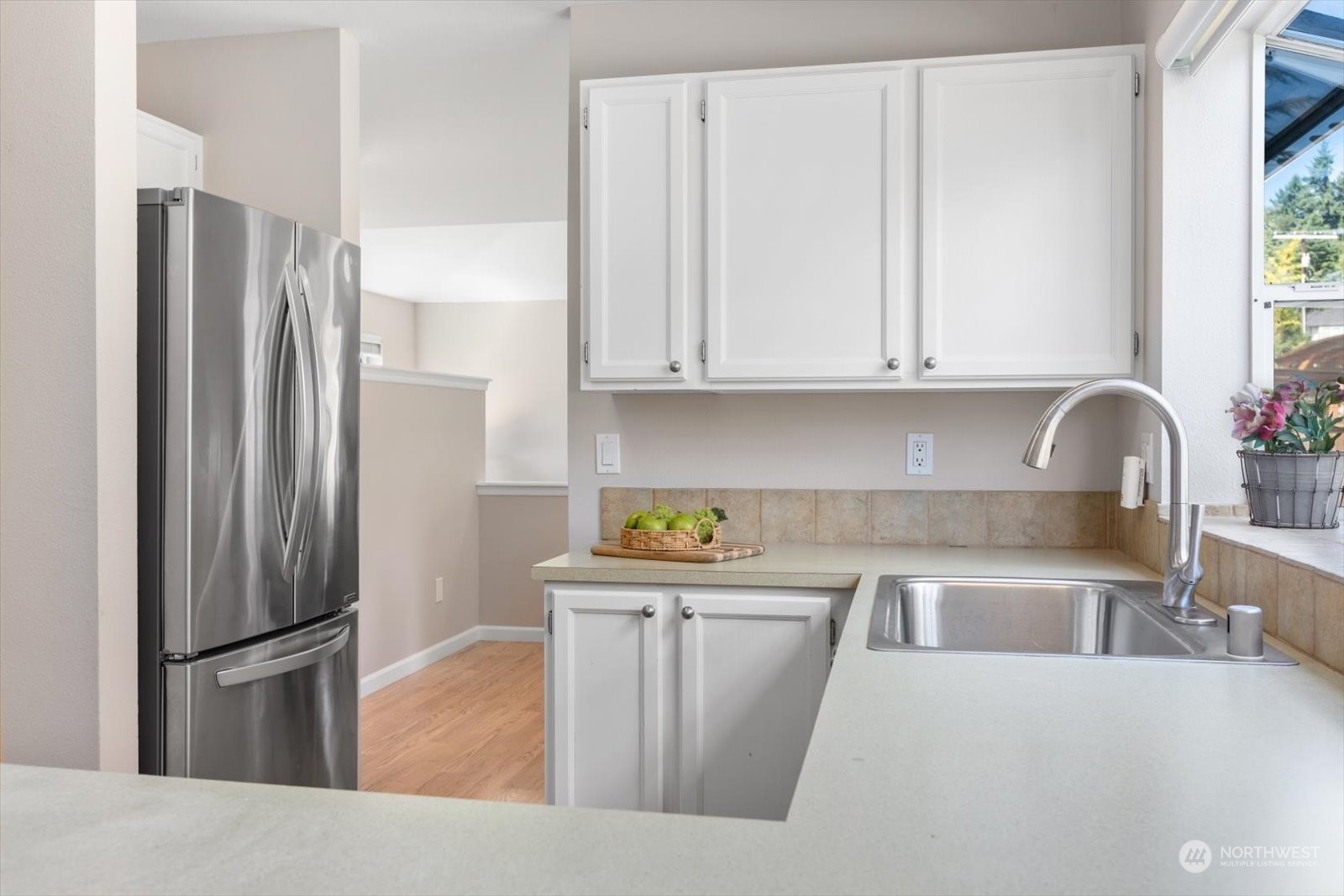 815 213th Street Southeast Bothell, WA 98021 - Photo 10 of 37 a kitchen with stainless steel appliances granite countertop a refrigerator a sink a stove and white cabinets