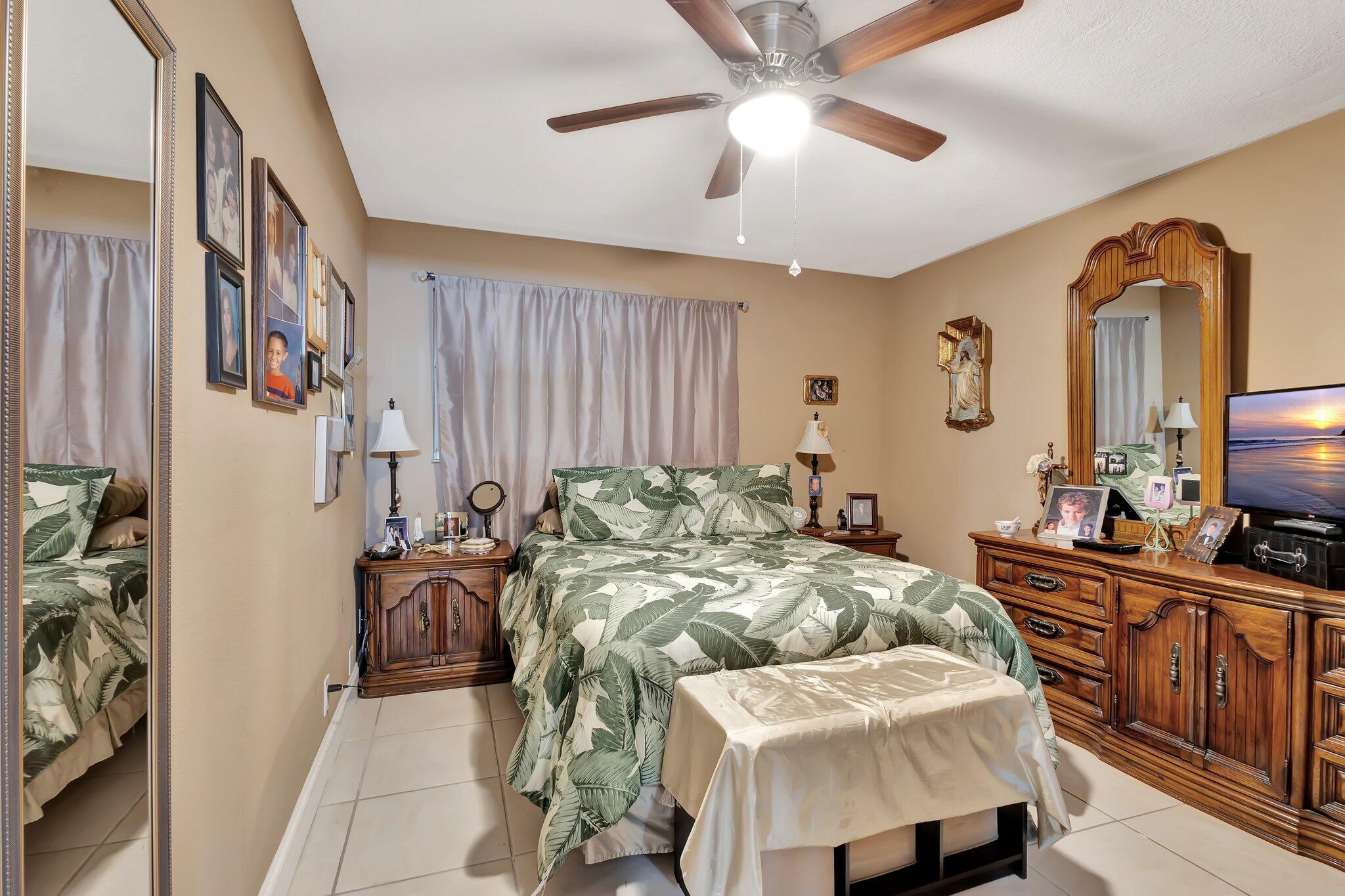 637 Monaco Court, Unit 637 Delray Beach, FL 33446 - Photo 11 of 58 a bed room with a bed and a television