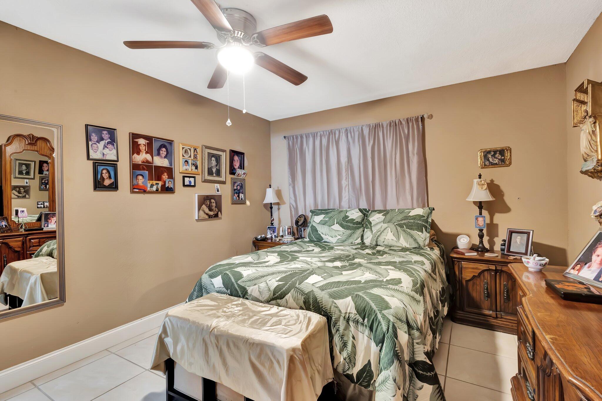 637 Monaco Court, Unit 637 Delray Beach, FL 33446 - Photo 12 of 58 a bedroom with a bed and a table in it