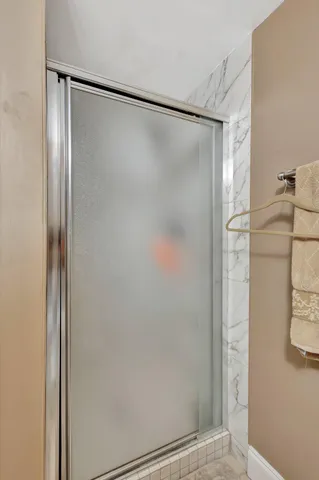 a bathroom with a glass shower door