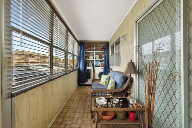 a living room with furniture and a floor to ceiling window