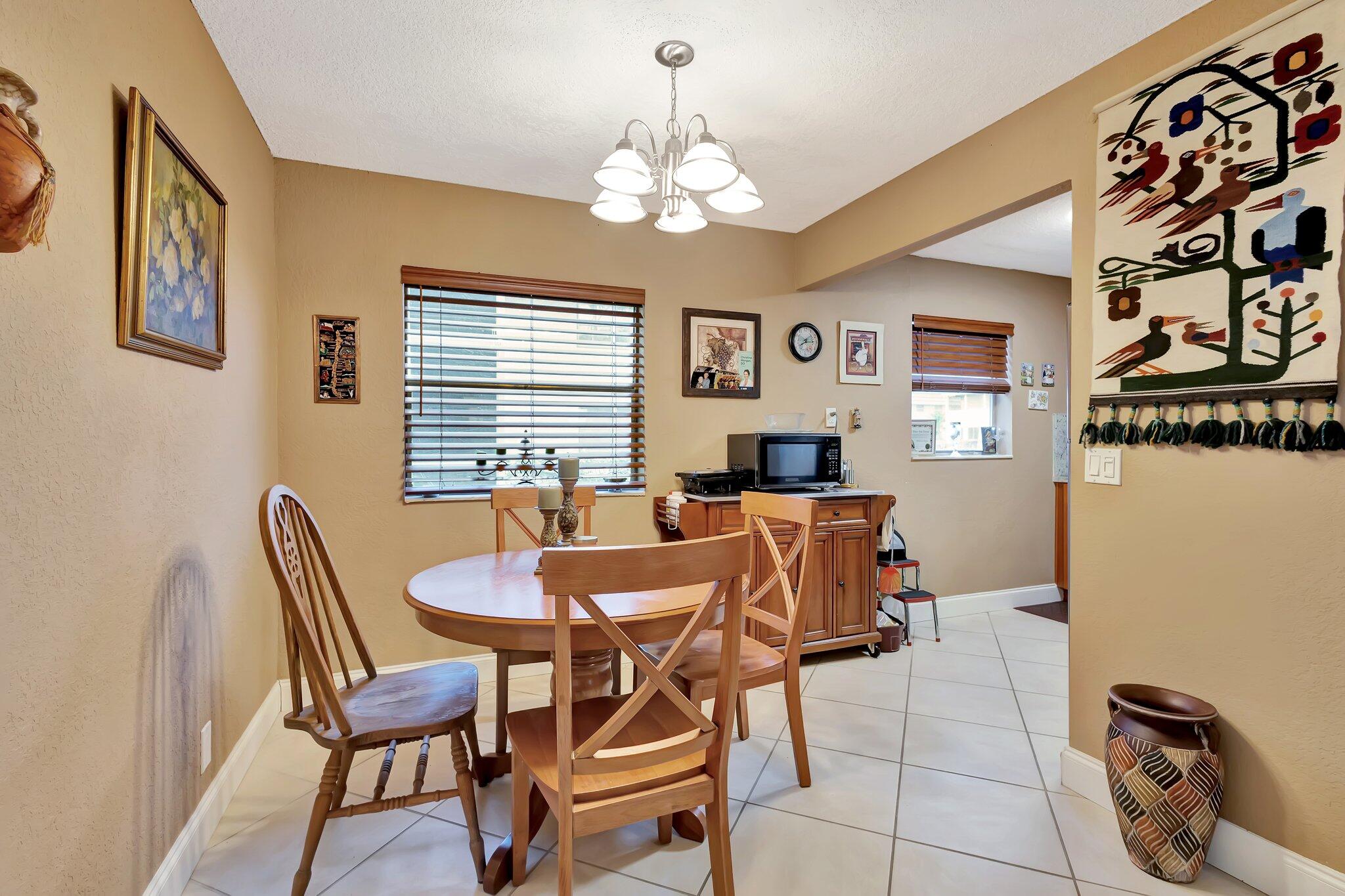 637 Monaco Court, Unit 637 Delray Beach, FL 33446 - Photo 4 of 58 a dining room with chandelier and wooden floor