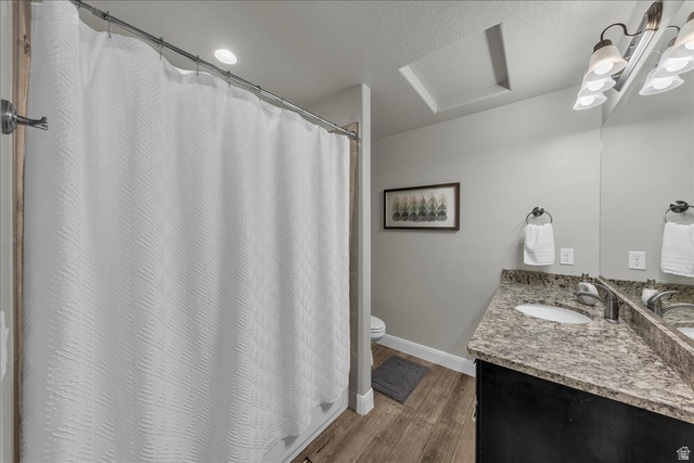 4796 Winged Foot Drive St. George, UT 84770 - Photo 28 of 33 Full bath featuring a shower with shower curtain, vanity, dark wood finished floors, and a textured ceiling