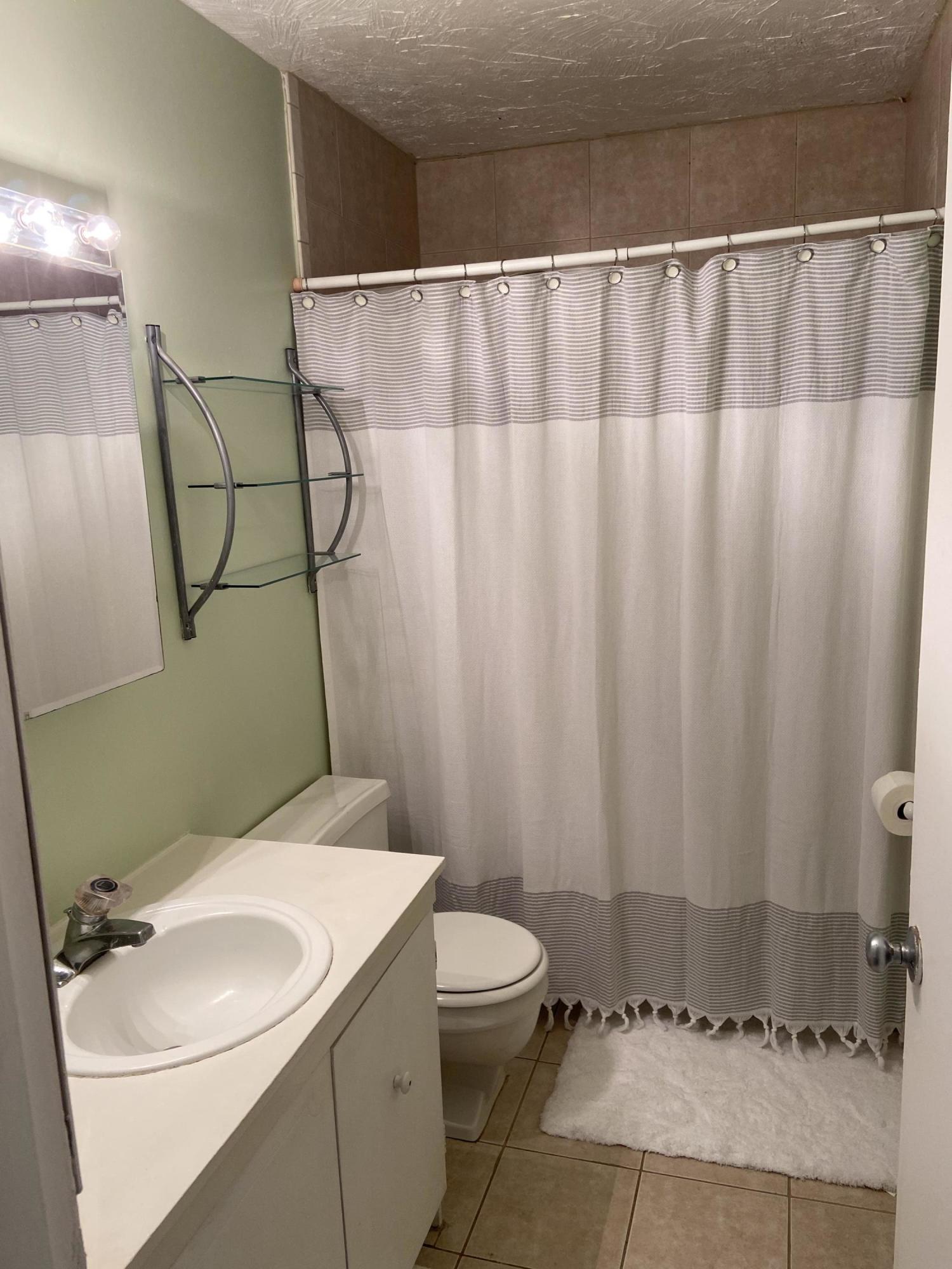 7 Roberta Drive, Unit G Buzzards Bay, MA 02532 - Photo 11 of 13 a bathroom with a sink a toilet and shower curtain