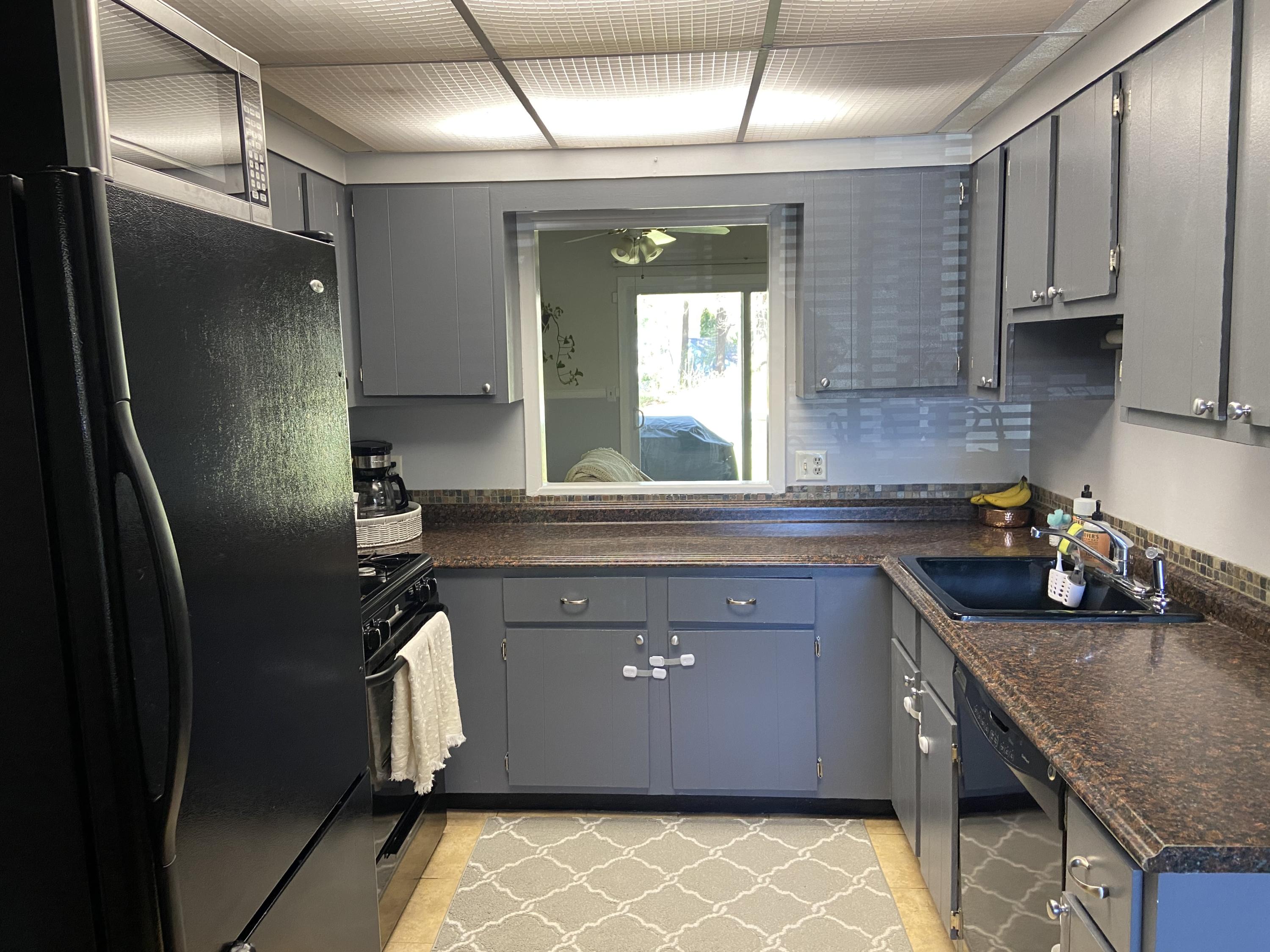 7 Roberta Drive, Unit G Buzzards Bay, MA 02532 - Photo 7 of 13 a kitchen with stainless steel appliances granite countertop a sink a stove and a refrigerator