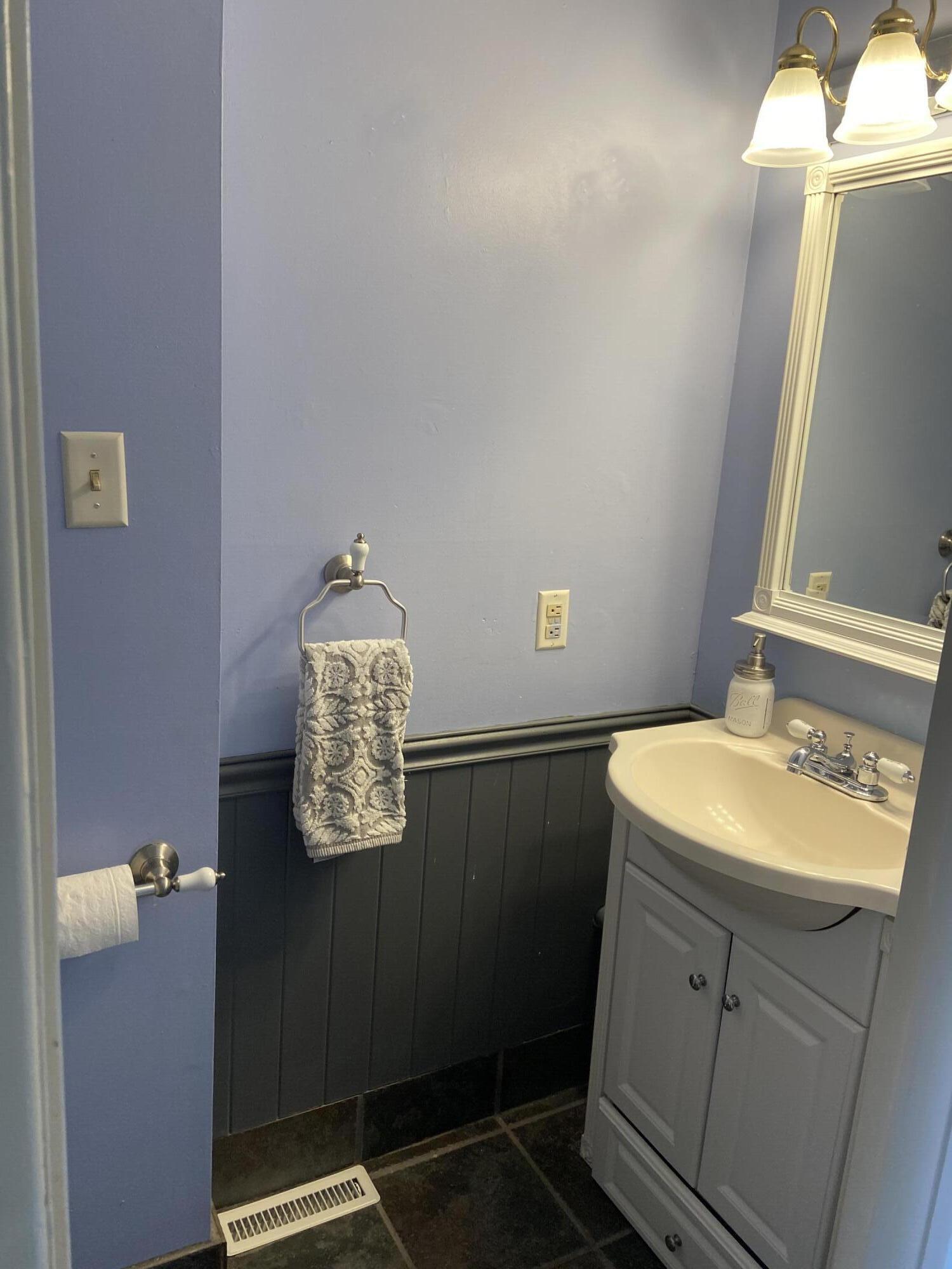 7 Roberta Drive, Unit G Buzzards Bay, MA 02532 - Photo 9 of 13 a bathroom with a sink and a mirror