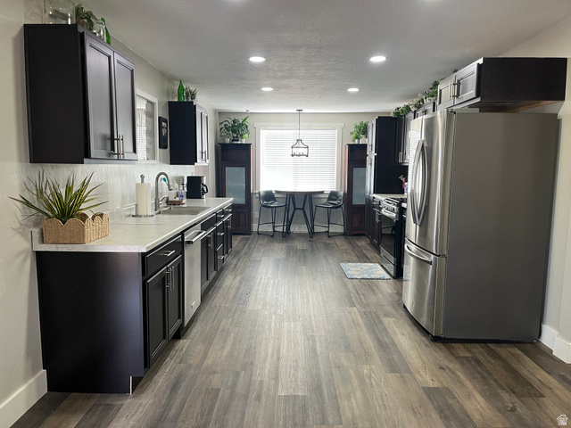 558 North N Cres Road Roosevelt, UT 84066 - Photo 29 of 31 Spacious kitchen featuring dark cabinetry, stainless steel appliances, light countertops, wood-finish flooring, and recessed lighting