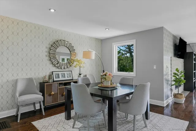 a view of a dining room with furniture window and wooden floor