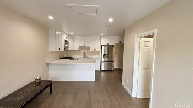 a kitchen with a refrigerator and a sink