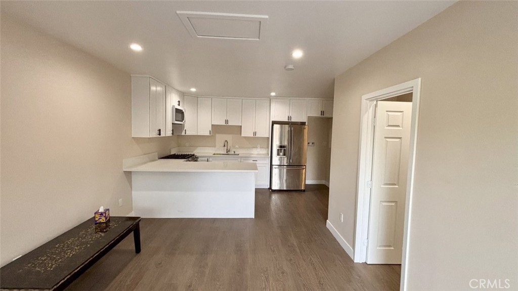 9981 Stanwin Avenue Arleta, CA 91331 - Photo 3 of 6 a kitchen with a refrigerator and a sink