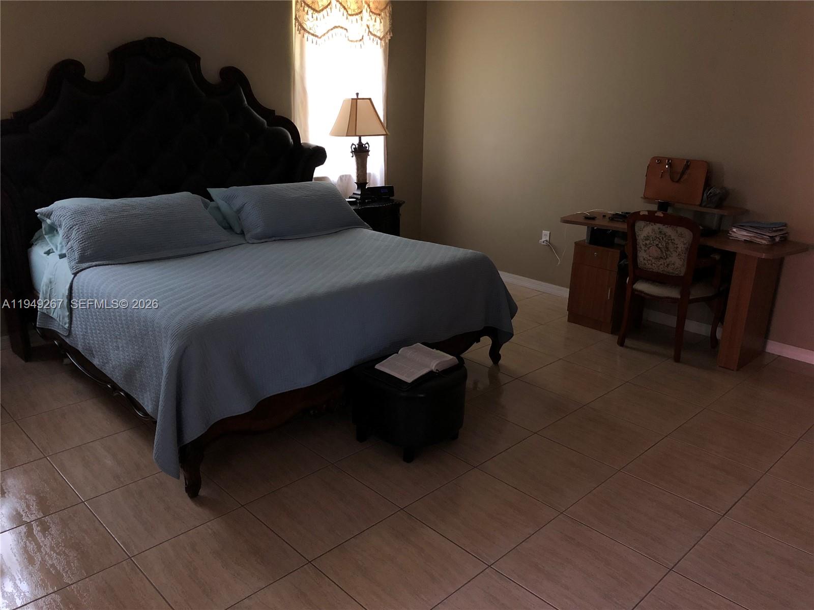 15364 Southwest 32nd Terrace Miami, FL 33185 - Photo 11 of 14 a bedroom with a bed and a chair