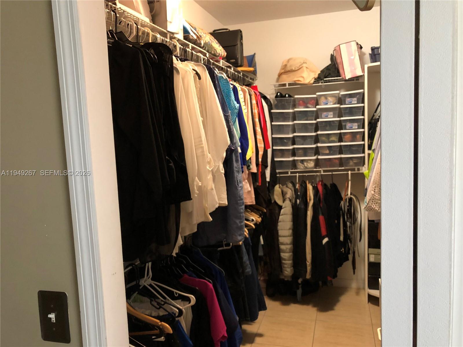 15364 Southwest 32nd Terrace Miami, FL 33185 - Photo 12 of 14 a view of walk in closet with clothes and shoes