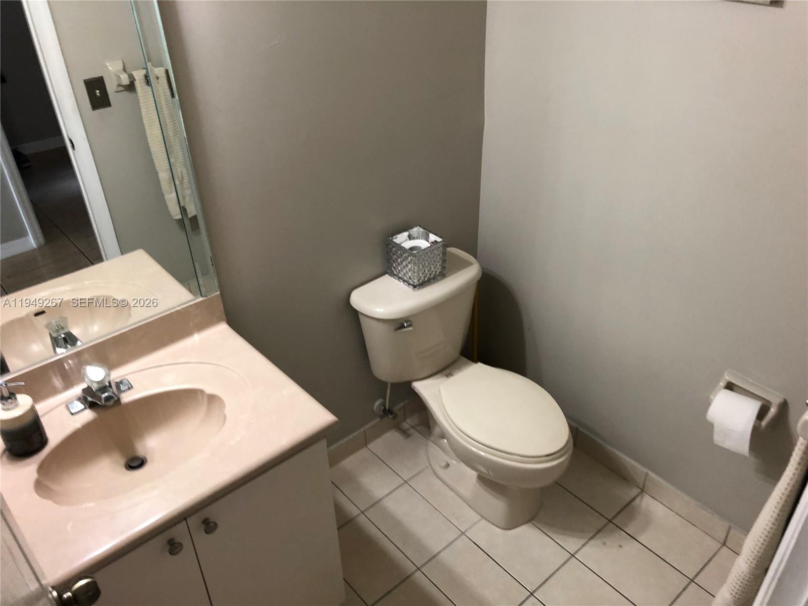 15364 Southwest 32nd Terrace Miami, FL 33185 - Photo 7 of 14 a white toilet sitting next to a bathroom sink