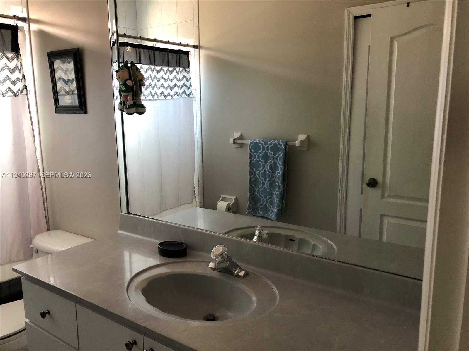 15364 Southwest 32nd Terrace Miami, FL 33185 - Photo 10 of 14 a bathroom with a sink and mirror