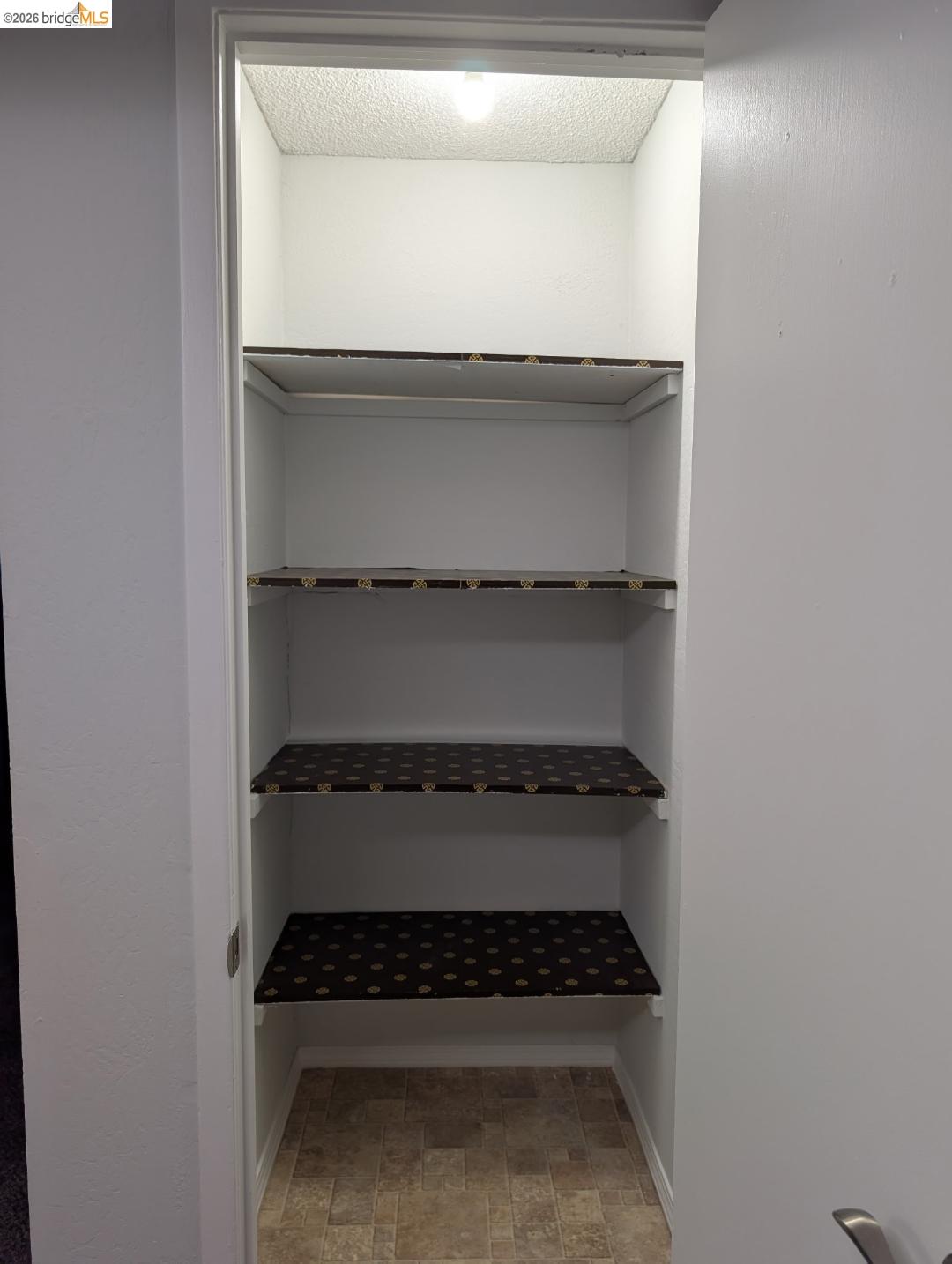 4260 Clayton Road, Unit 46 Concord, CA 94521 - Photo 16 of 20 Recessed shelving unit featuring four storage shelves, interior lighting, and durable flooring