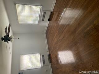 41 Woodbine Road East Hills, NY 11577 - Photo 13 of 15 an empty room with wooden floor and windows