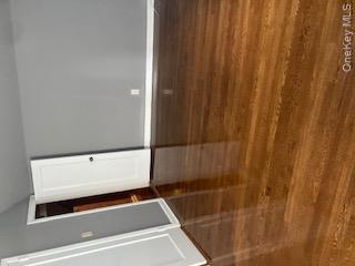 41 Woodbine Road East Hills, NY 11577 - Photo 14 of 15 Empty room featuring dark wood-type flooring and lofted ceiling