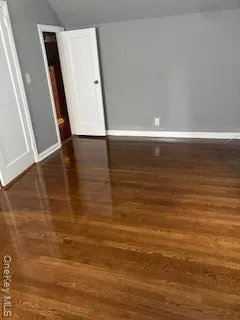 a view of a room with wooden floor