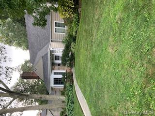 41 Woodbine Road East Hills, NY 11577 - Photo 3 of 15 a front view of a house with a garden
