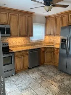 a kitchen with stainless steel appliances granite countertop a stove sink and cabinets