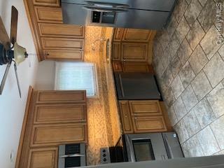41 Woodbine Road East Hills, NY 11577 - Photo 7 of 15 Kitchen with ceiling fan, brown cabinets, tasteful backsplash, refrigerator, and stove