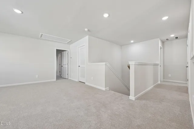 a spacious bathroom with a double vanity sink a mirror and a