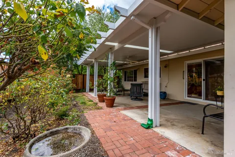 a view of a house with backyard and sitting area