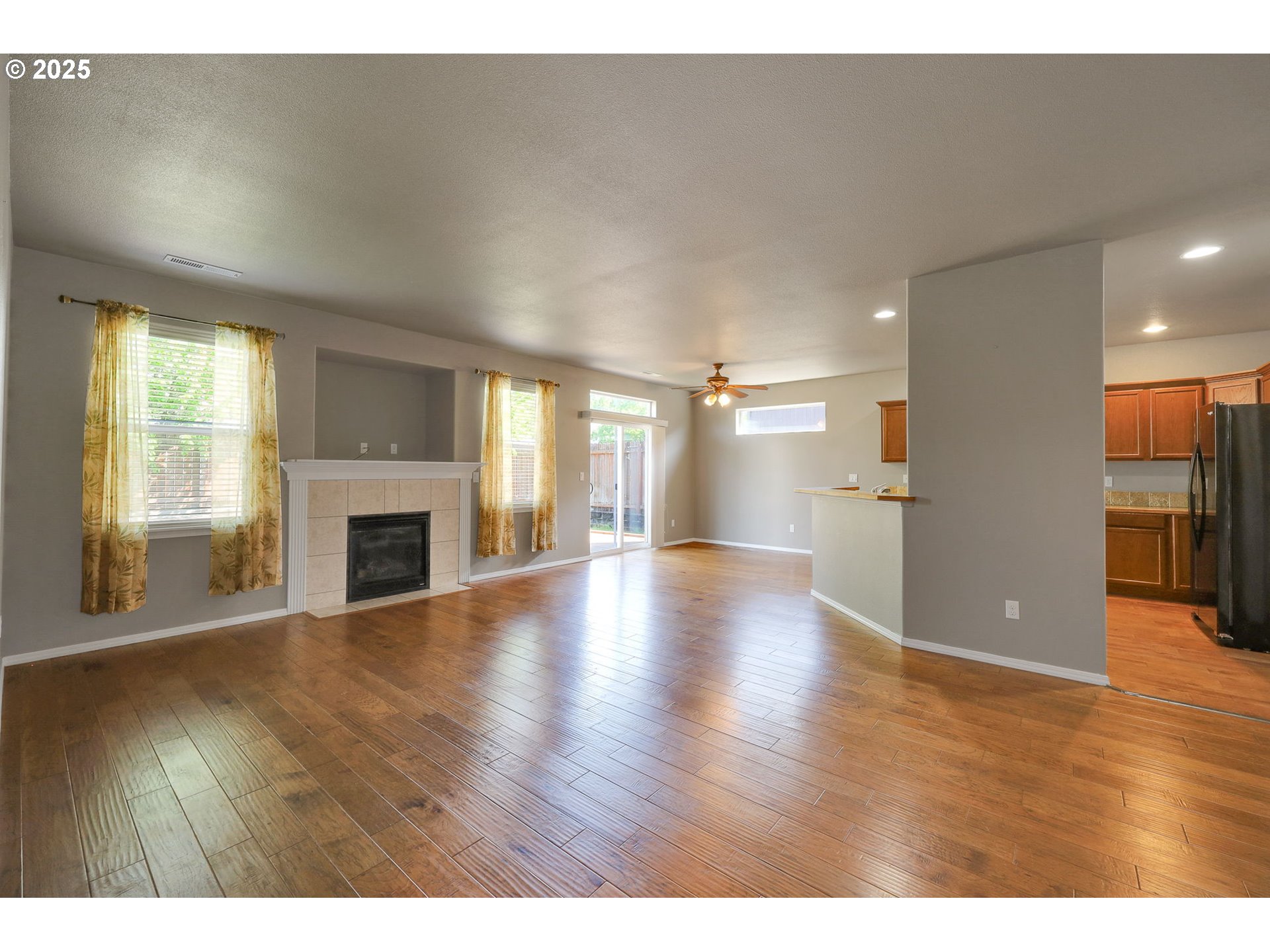 5770 Mineral Way Springfield, OR 97478 - Photo 4 of 18 a view of an empty room with wooden floor fireplace and a window
