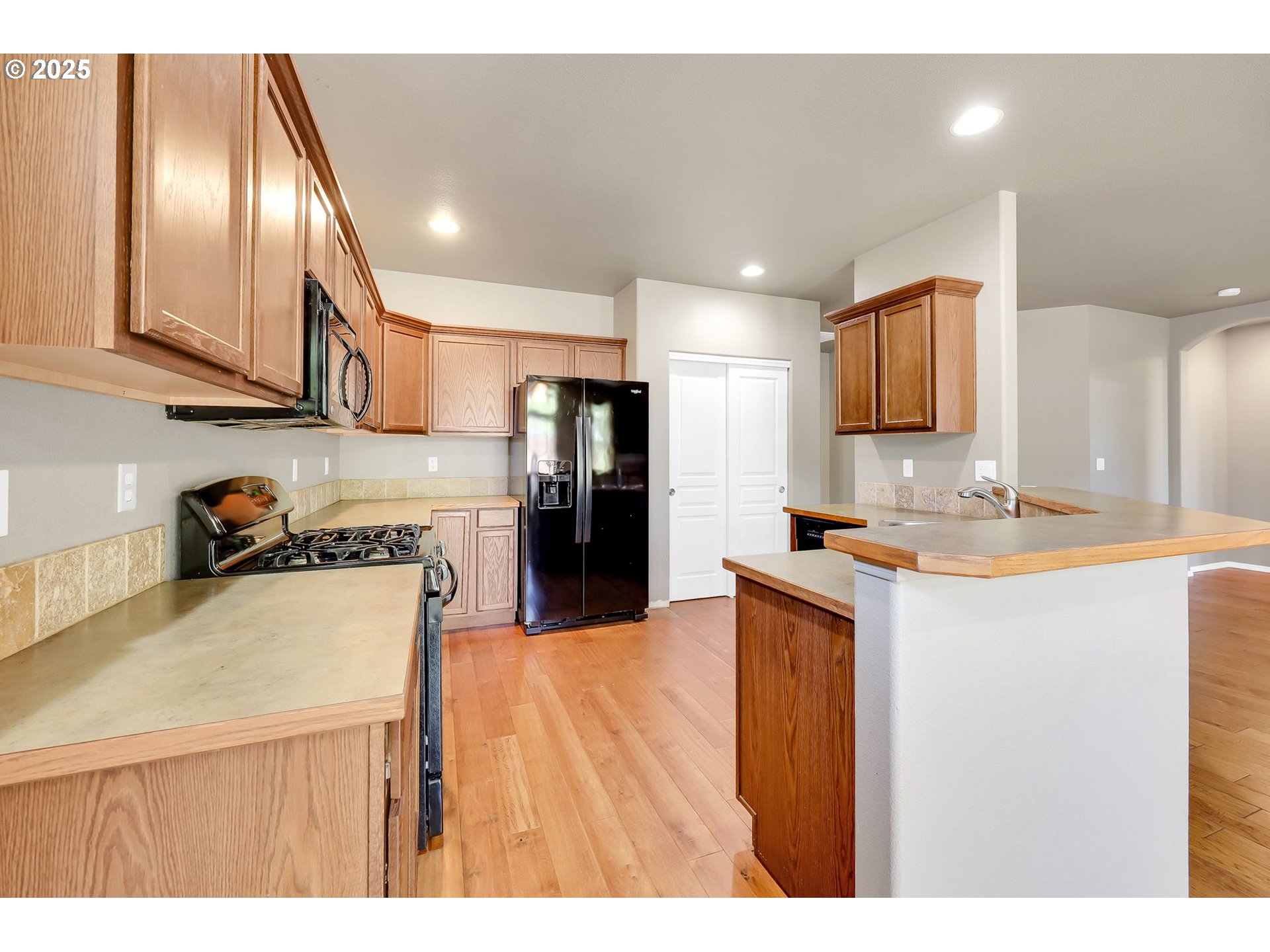 5770 Mineral Way Springfield, OR 97478 - Photo 6 of 18 a kitchen with stainless steel appliances granite countertop a sink refrigerator and microwave