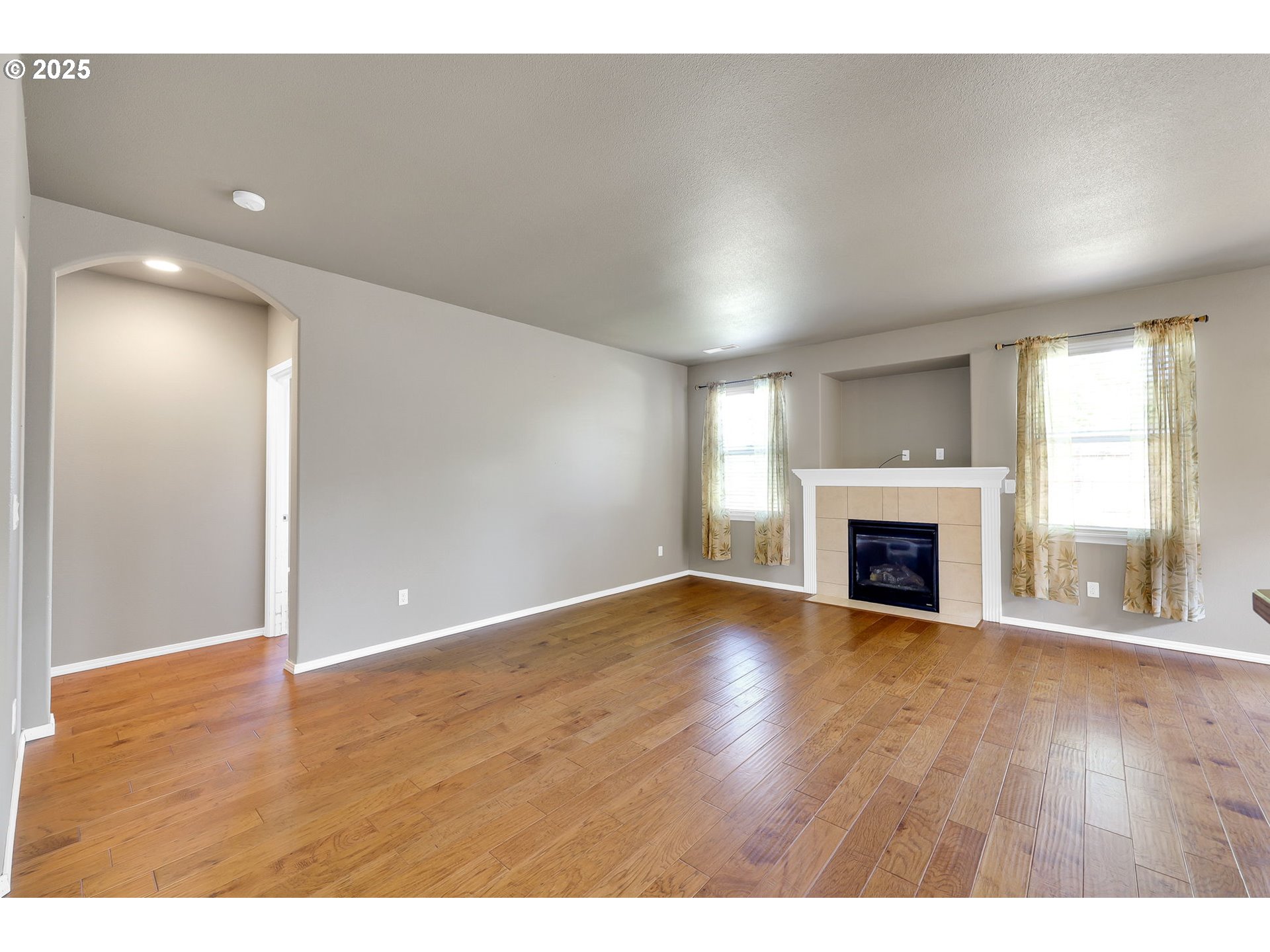 5770 Mineral Way Springfield, OR 97478 - Photo 9 of 18 a view of empty room with wooden floor and fireplace