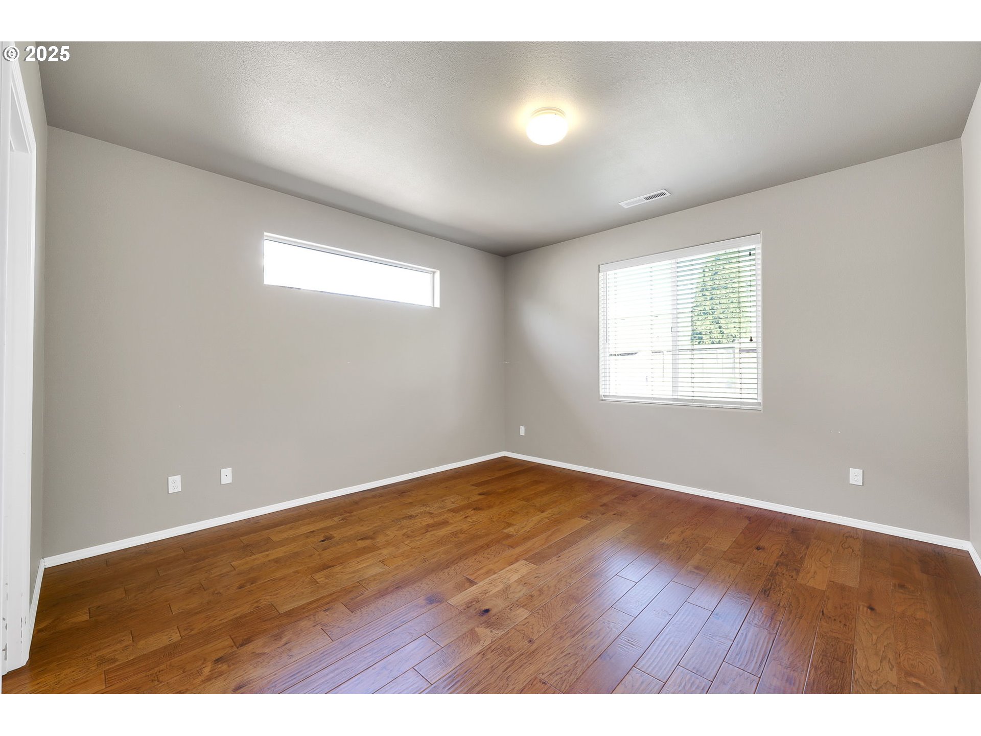 5770 Mineral Way Springfield, OR 97478 - Photo 10 of 18 an empty room with wooden floor and windows