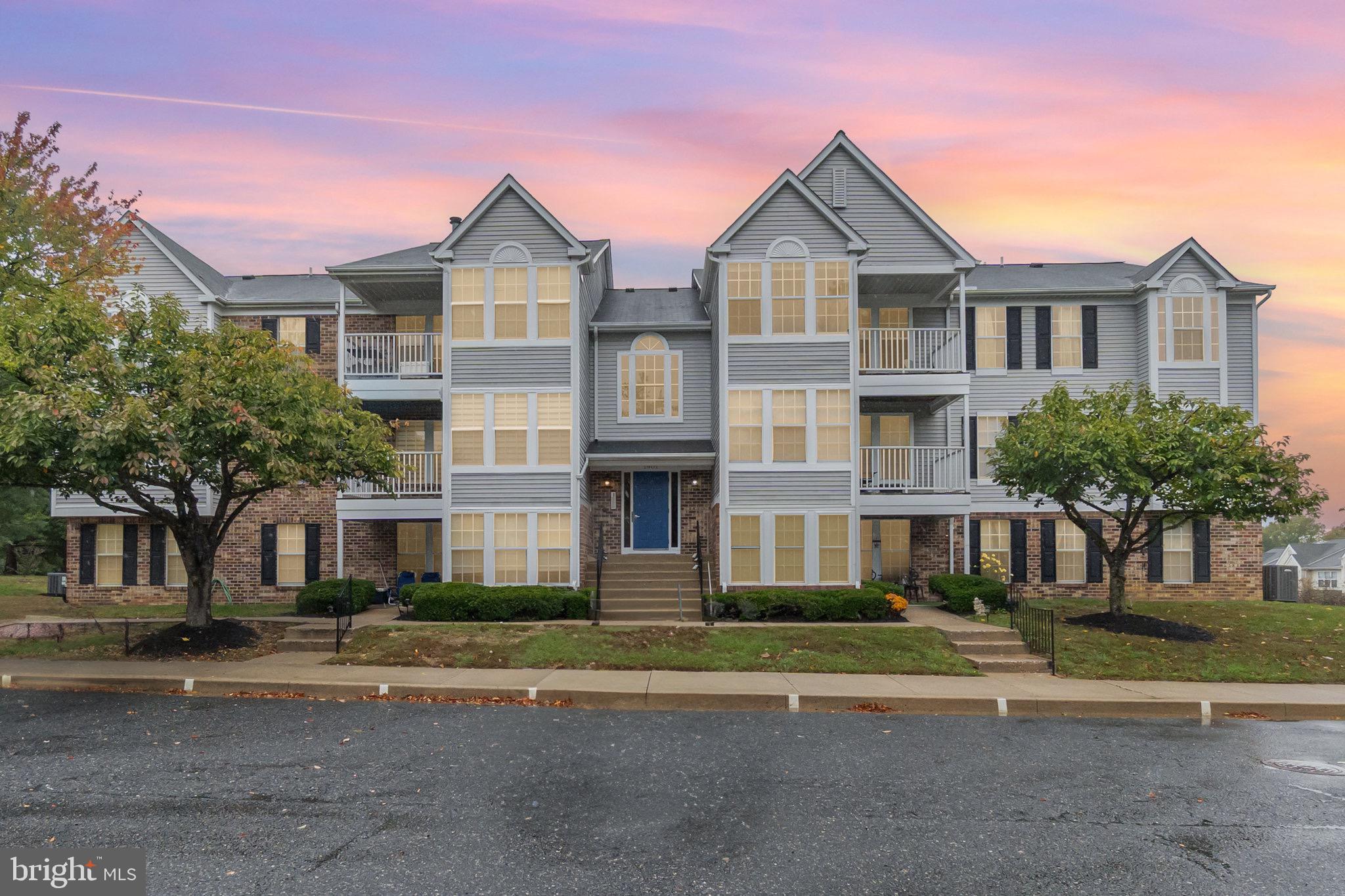 front view of a brick house next to a yard