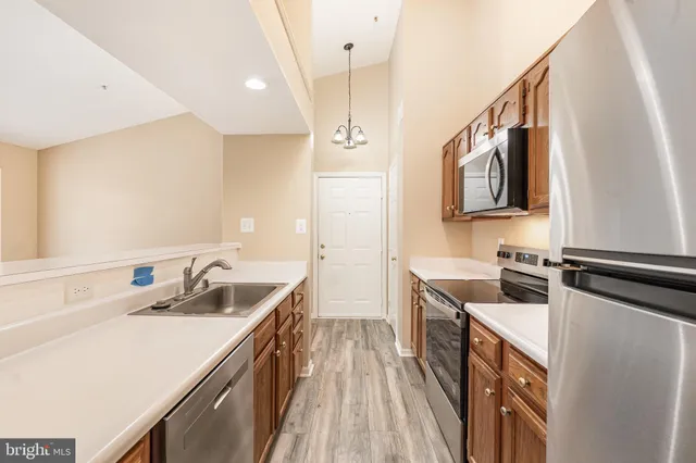 a kitchen with a sink stove and refrigerator