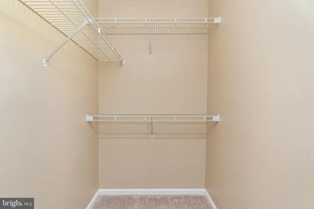 a view of a room with wooden floor and entryway