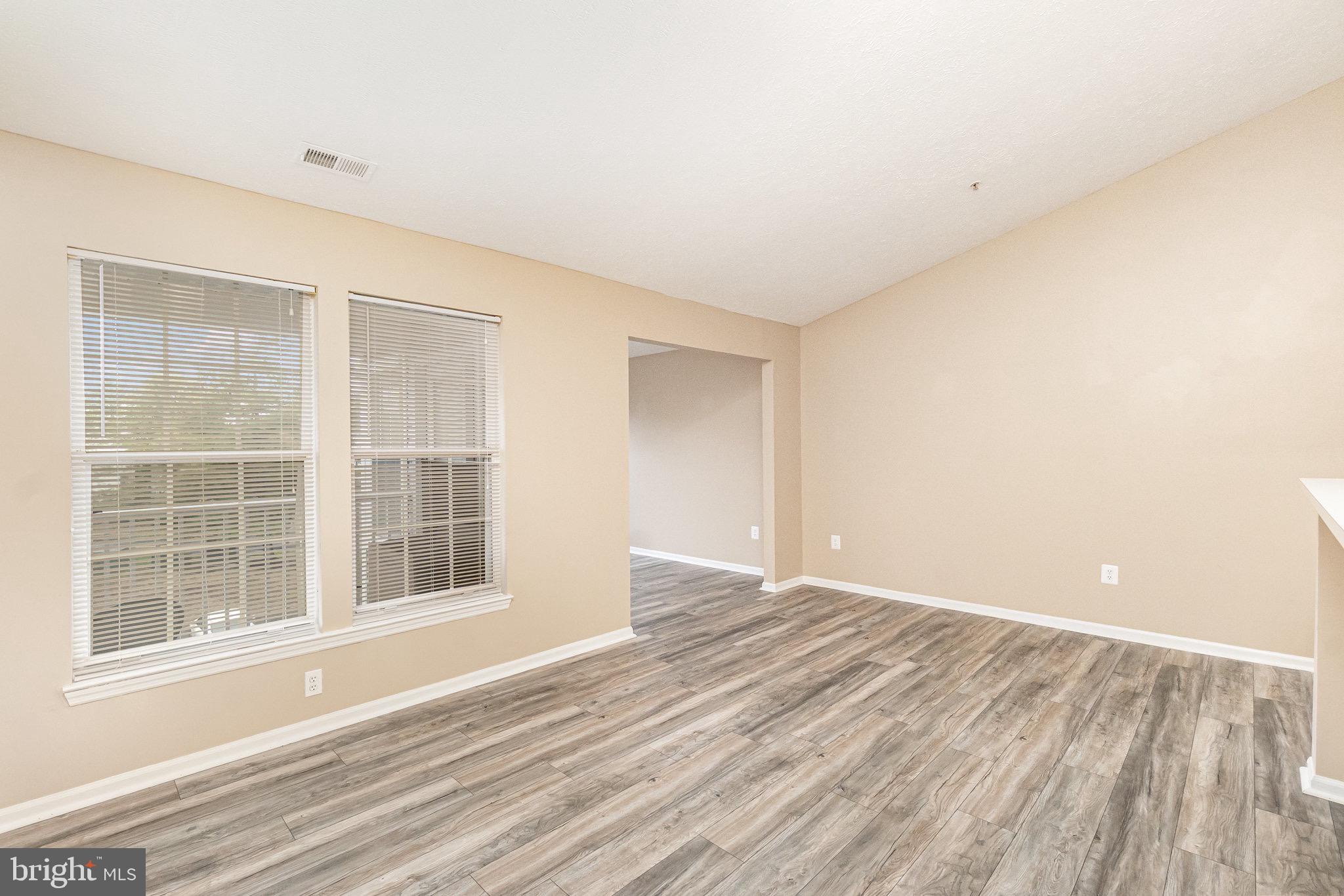 1401 Sage Lane, Unit 1401M Belcamp, MD 21017 - Photo 6 of 30 an empty room with wooden floor and windows
