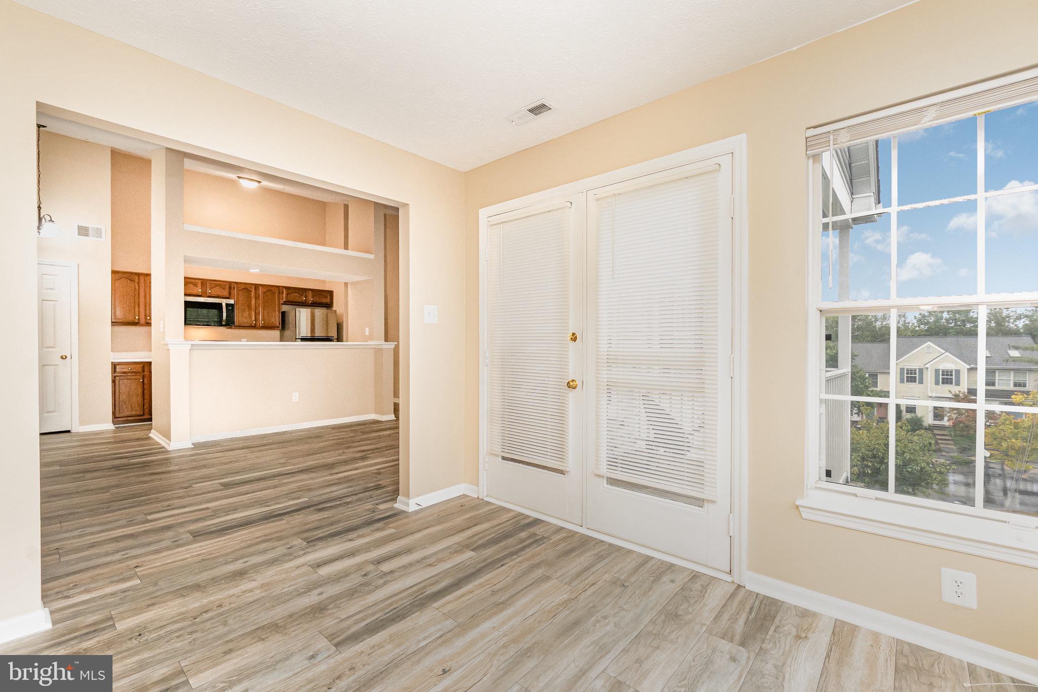 1401 Sage Lane, Unit 1401M Belcamp, MD 21017 - Photo 9 of 30 a view of wooden floor and windows in a room