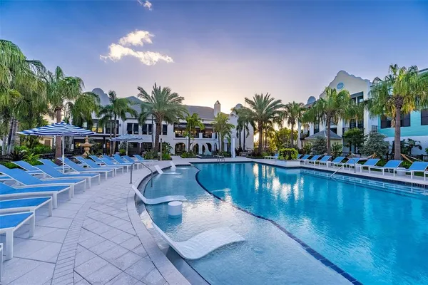 a view of a swimming pool with outdoor seating and plants